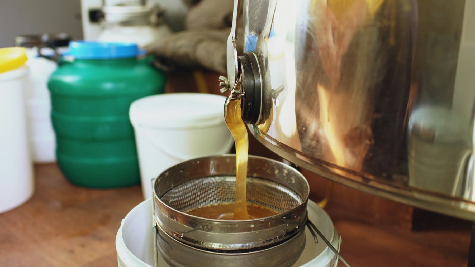 Honey being filtered into a collection container
